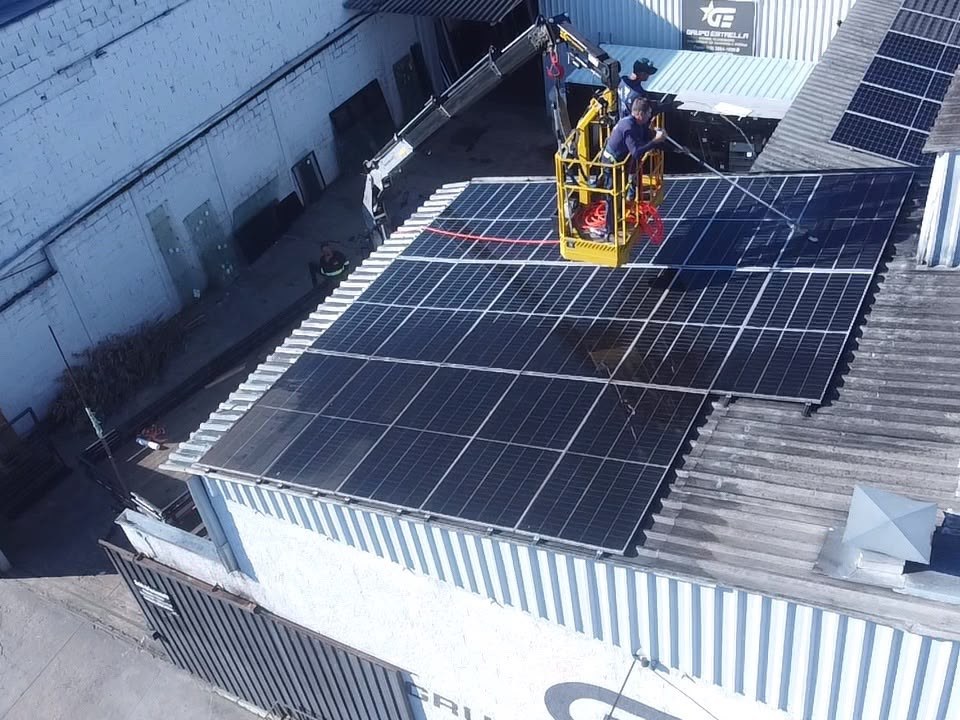 Equipe da MV EnergySol na limpeza das placas de um telhado comercial